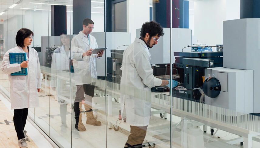 Scientists in a laboratory working with biopharmaceutical equipment, illustrating regulatory frameworks for single-use systems.