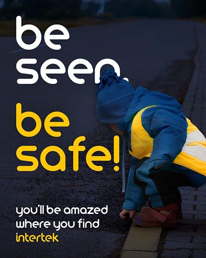 Child wearing bright, reflective raingear