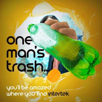 An empty plastic water bottle being dropped into a bag